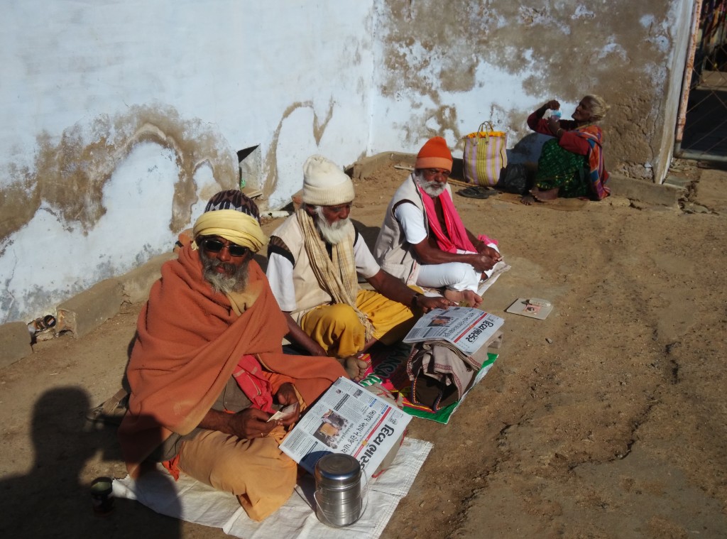 Beggars reading newspaper